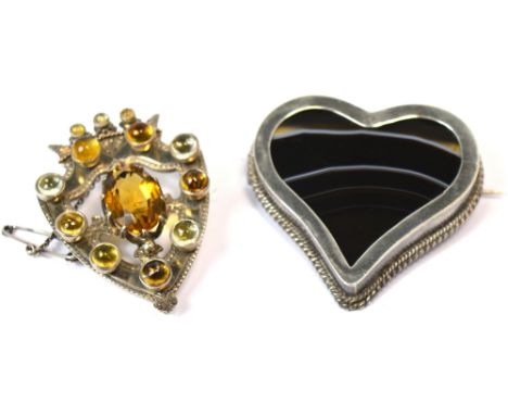Two vintage brooches, a heart shaped onyx brooch in silver mount and a white metal shield shape brooch set with semi precious