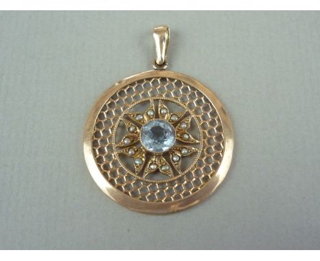 An aquamarine, split seed pearl and yellow metal pendant, of target form, with central round-cut and millegrain set aquamarin