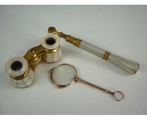A pair of early 20th Century gilt metal and mother of pearl opera glasses with telescopic handle, engraved with the name ' Mr