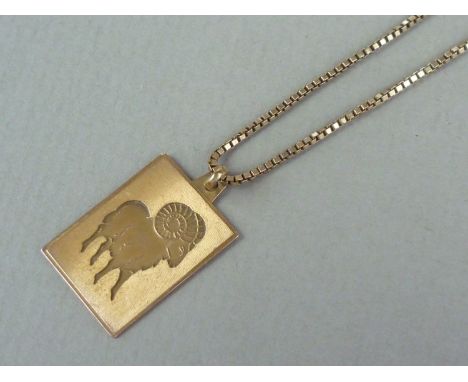 A 9ct gold zodiacal pendant, engine turned and impressed with the image of Aries the ram, on a 9ct gold box link neck chain, 