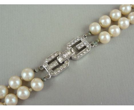 A vintage Givenchy costume jewellery faux pearl necklace, with two strands of uniform pearls suspended from a paste set box c