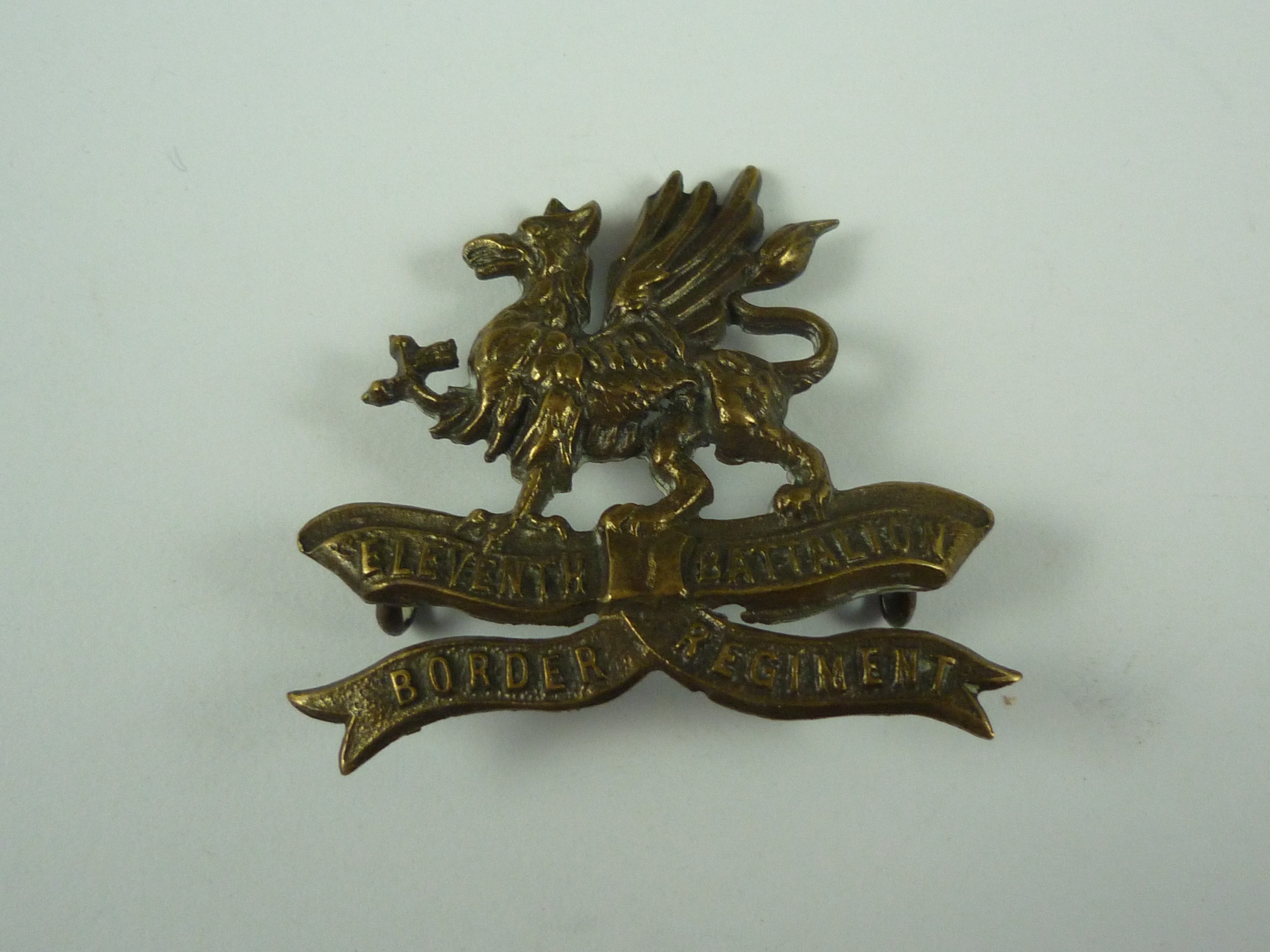 An Eleventh (Lonsdale) Battalion Border Regiment brass cap badge