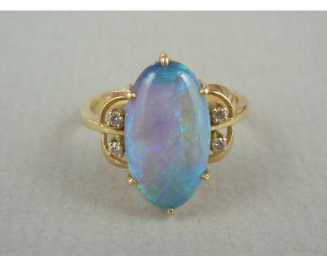 A black opal, diamond and high carat gold dress ring, the opal measuring approximately 15 x 8.25 x 4 mm, crown set and flanke