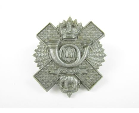 A Highland Light Infantry plastic cap badge