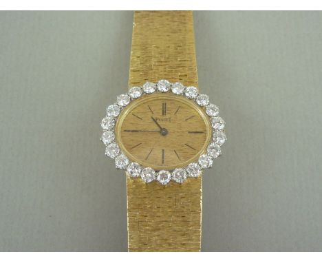 A Piaget 18ct gold and diamond cocktail watch, having crown wound movement, textured oval face with baton numerals and diamon