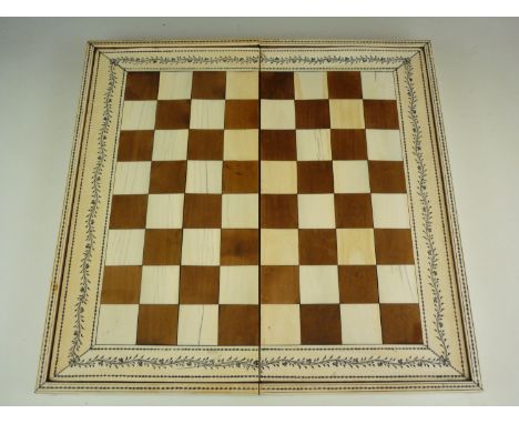 An early 19th Century Anglo-Indian Vizagapatam ivory, ebony and sandalwood folding chess and backgammon board, decorated with