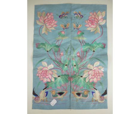 A pair of 19th Century oriental silk embroidery panels, tacked together and worked in mirror image depicting lotus blossom, b