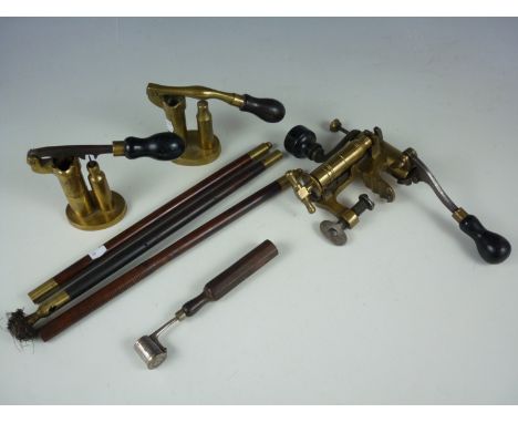 A group of late 19th Century gun tools including cartridge makers, a powder measure and barrel cleaning rod
