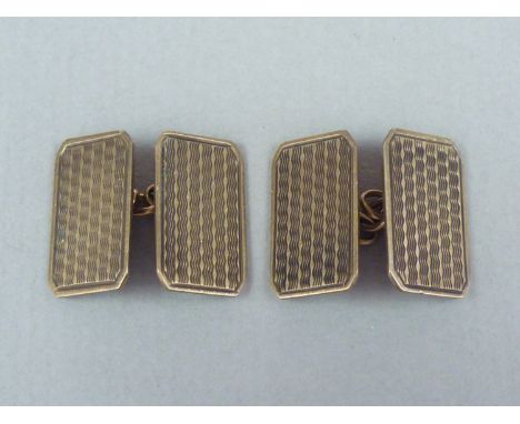 A gentleman's pair of vintage yellow metal cuff links, of square section with canted corners and engine turned decoration, st