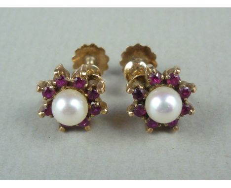 A pair of vintage ruby, pearl and yellow metal earrings, in a flower head cluster arrangement, stamped 9ct, test as gold