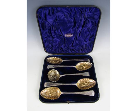A cased set of Victorian parcel gilt silver berry and dredging spoons, of old English pattern, with repousse moulded, chased 