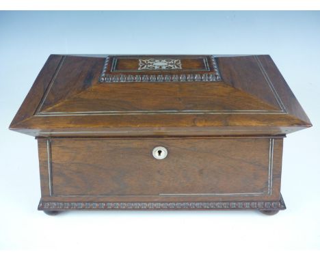 An early Victorian mother of pearl inlaid rosewood tea caddy, of sarcophagus form, raised over four bun feet, opening to reve
