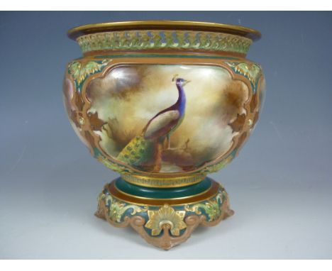 A 19th Century Royal Worcester Hadley Ware footed cachepot, hand enamelled in the round with peacocks standing in a misty woo