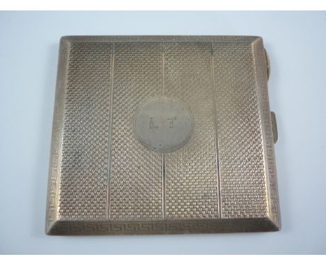 A George V silver cigarette case, of square section, with engine turned banded decoration within a Greek key border, bearing 