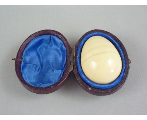 A late 19th Century Pepys & Co novelty ivory etui in the form of an egg, opening to reveal a needle case and bobbin, in fitte