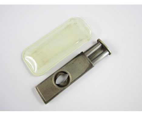 An Elizabeth II silver cigar cutter, with engine turned decoration, Birmingham, 1971, 13.2g