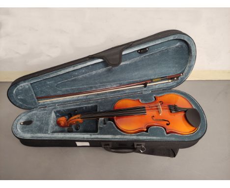 Modern 1/2 size violin by Stagg. Spruce top and two piece maple back. Complete with case and bow. 