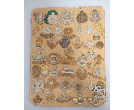 British Militaria Interest. Tray containing a large quantity of cap badges to include seven Border Regiment cap badges and a 