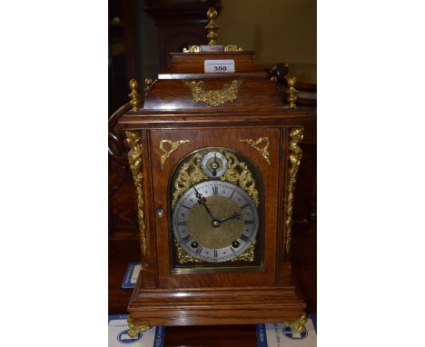 An early 20th century German mantel clock, the 11 cm brass dial with Roman numerals, in an oak case, 25 cm high 