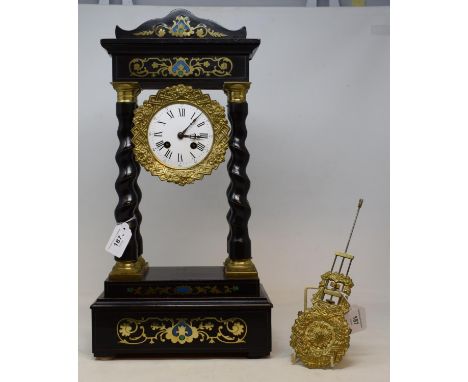 An early 20th century ebonised and gilt metal portico  clock, the 10 cm diameter enamel dial with Roman numerals, fitted an e