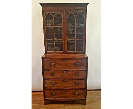 A 19th century mahogany secretaire bookcase, having a pair of bar glazed doors above a secretaire drawer, with three graduate