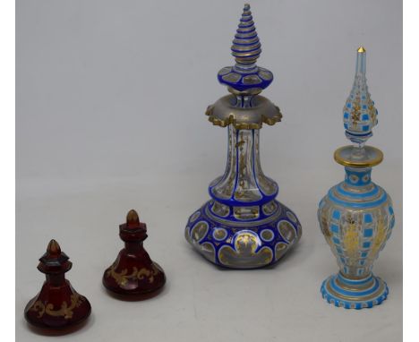 A 19th century Bohemian blue and clear cased glass decanter,  26 cm high, another in turquoise, 24 cm high, and a pair of rub