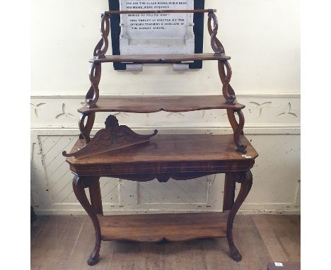 A 19th century Continental walnut bookcase/shelf unit, having three graduated tiers on a base with a plain frieze with cabrio