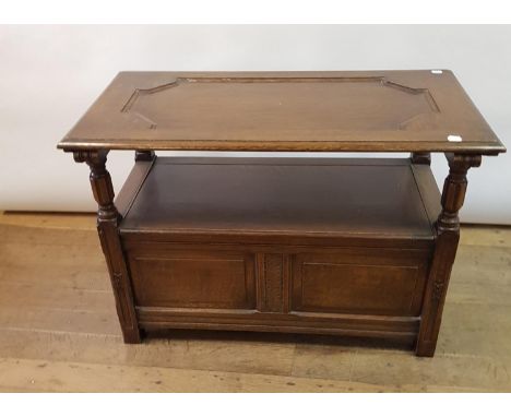 An 18th century style oak monks bench, 107 cm wide 