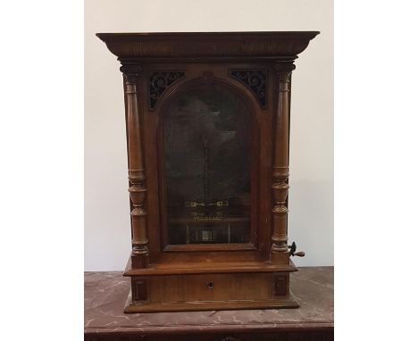 A late 19th century coin operated polyphon by Joseph Riley and Son, playing  50 cm discs,  in a walnut case, 82 cm high,  wit