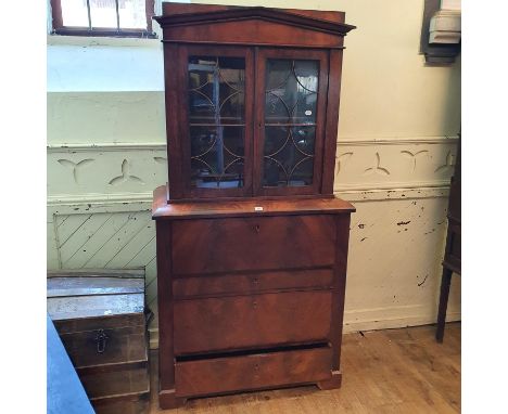 A Biedemeir mahogany secretaire bookcase, having a pair of bar glazed doors above a secretaire drawer with three long drawers