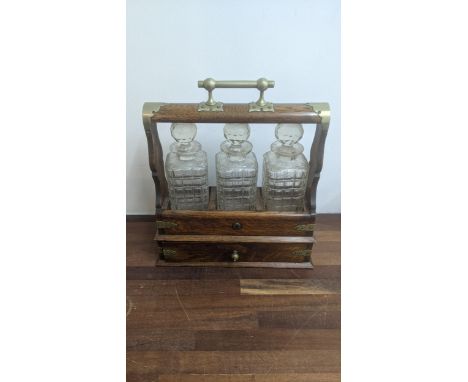 An oak cased tantalus with three glass decanters, a drawer with keysLocation: A1FIf there is no condition report, please requ