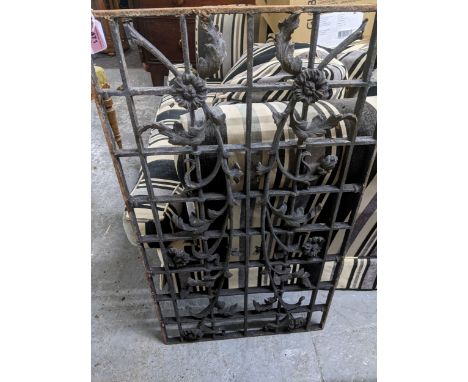 A selection of cast and wrought iron garden items to include a decorative grill or trellis with floral decoration, a cast iro