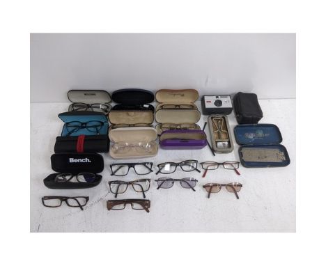 Assorted fashion glasses, some with cases and some loose, and a Kodak Instamatic, a Rolls Razor A/F and a group of empty sung