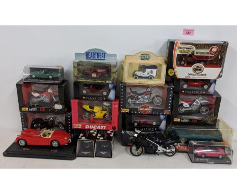 A collection of boxed model vehicles to include Harley Davidson models a Burago Jaguar XK120 Roadster 1949, Matchbox collecti