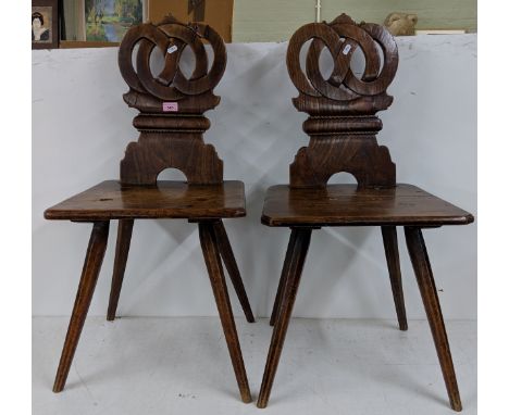 A pair of oak Swiss Alps Folk Art Escabelle chairs with a carved back rest, square seat raised on splayed legs Location:If th