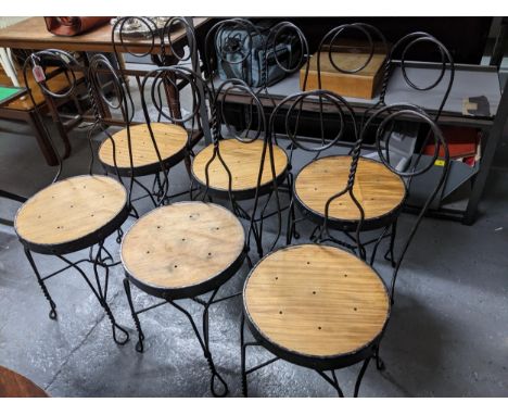 A set of six early 20th century French black painted and wrought iron framed ice cream parlour chairs with wooden penny seats