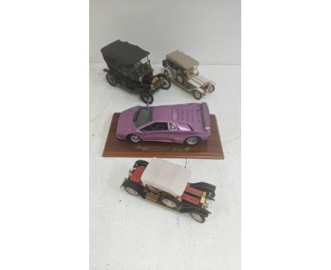 Diecast model vehicles to include a Gold Shield Lamborghini SE, a Franklin Mint Rolls Royce Silver Ghost and two others Locat