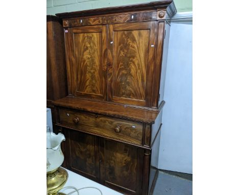 A Victorian figured mahogany secretaire bookcase, shaped and stepped cornice over twin fielded cupboard doors, adjustable int