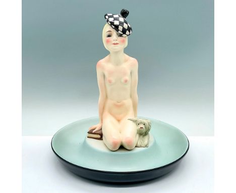 A round black exterior bowl with a pale blue interior glaze. A nude female figure, in a beret, kneeling on the center with a 