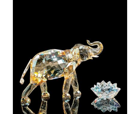 Spectacular amber crystal elephant mid-stride wit trunk lifted. Swarovski Crystal Society figure. Swarovski etched backstamp.