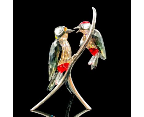 Depicts two black, red, and amber woodpeckers perched on a silver-colored branch. Swarovski backstamp. This item has its orig