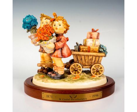 Produced in a limited edition, hand painted in matte finish modeled as a boy and girl pulling a wagon full of gifts. Part of 