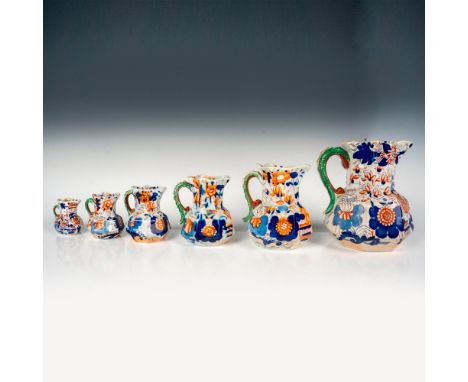 A set of 6 Mason's Imari pattern pitchers of different sizes that have octagonal bottoms and are decorated with green dragon 