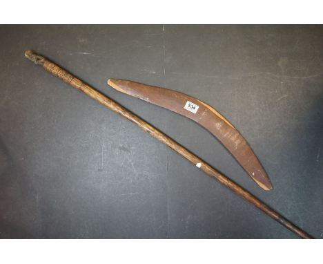 A vintage carved wooden boomerang with Emu decoration and a Wooden Staff 