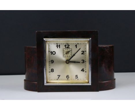 Art Deco Mantle Clock with a Square Dial contained in an Oak Stepped Frame with curved sides, 14cms high 