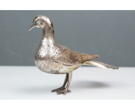 White metal model of a dove with fanned tail, turquoise-coloured eyes, stamped SEVAN to base, H13cm 