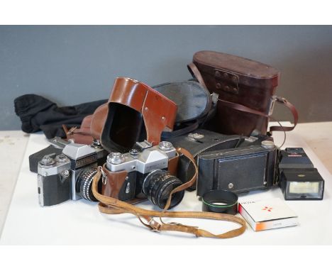 A collection of vintage camera equipment and binoculars to include Praktica and Halina. 