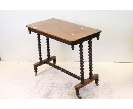 Victorian Mahogany Side Table raised on bobbin supports and cross-stretcher, raised on castors, 89cms long x 71cms high 