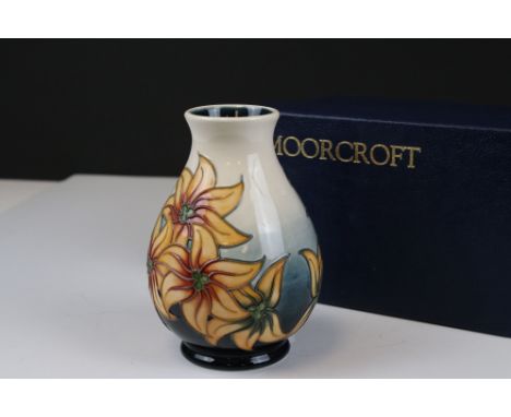 Moorcroft Vase decorated with Orange Flowers on a White and Teal ground., 14cms high, boxed 