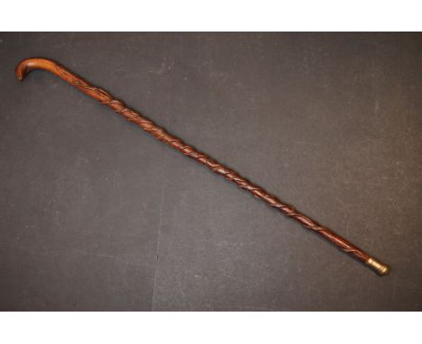 A vintage walking stick cane profusely carved with snakes / serpents. 